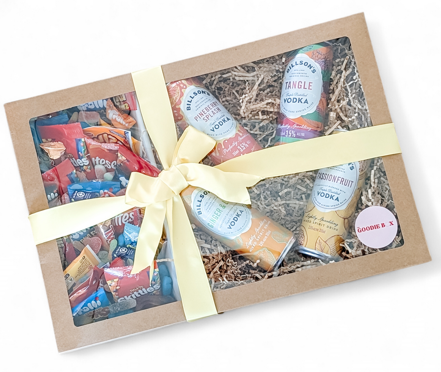 Photograph of large gift hamper wrapped in a lovely yellow bow. The gift box features 4 cans of Billson's Vodka and a mix of sweet treats and lollies.