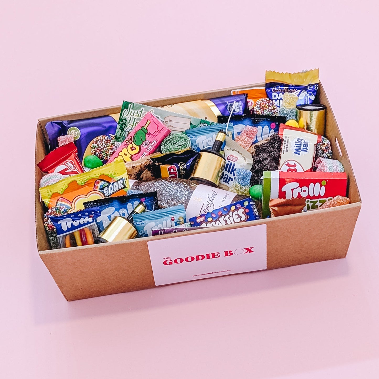Photograph of dessert birthday box for her featuring sparkling wine, party poppers, chocolates, cookies and lollies.