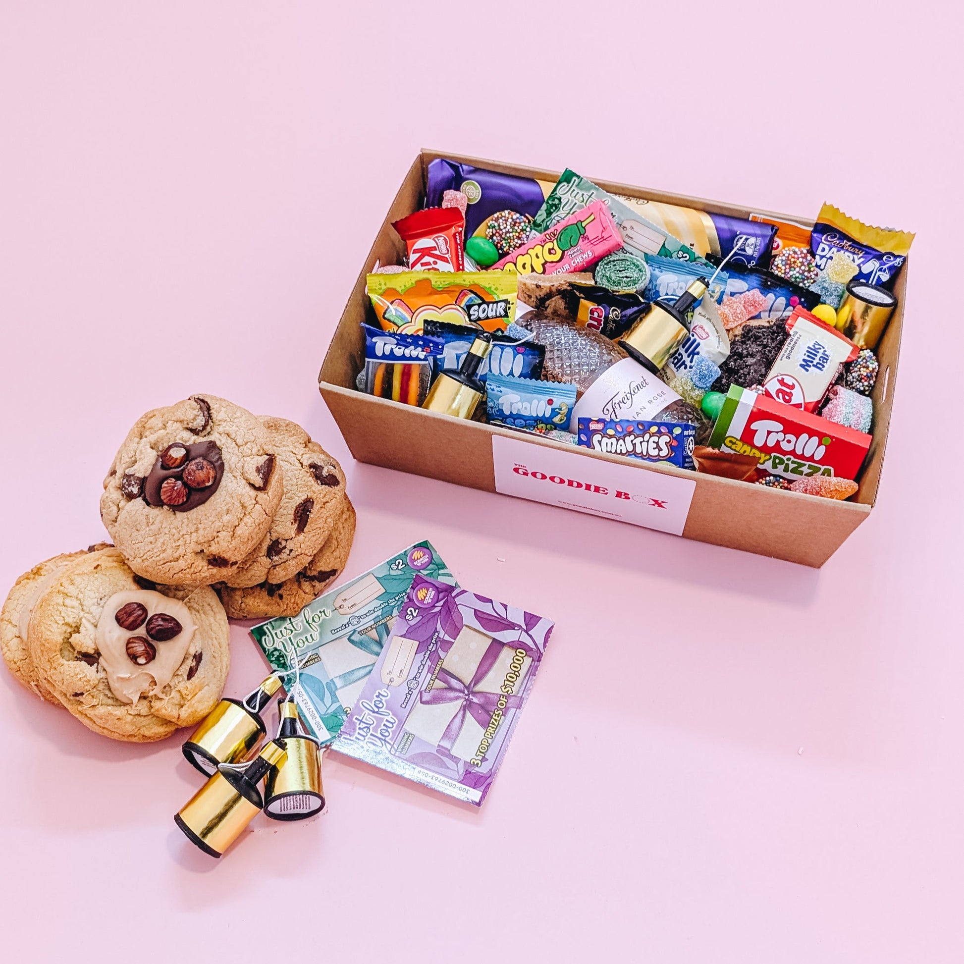 Photograph of chocolate gift hamper featuring Cadbury Caramilk, Freixenet Italian Rose, Cookies, and an assortment of chocolates and lollies.