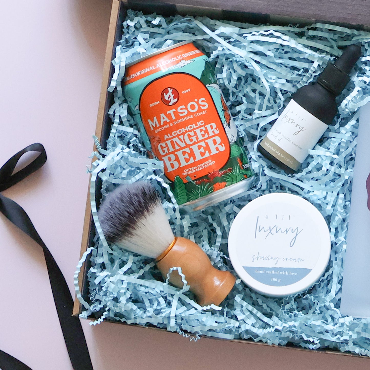 Shaving brush, shaving cream, beard oil and Matso's ginger beer in a Father's Day grooming gift hamper