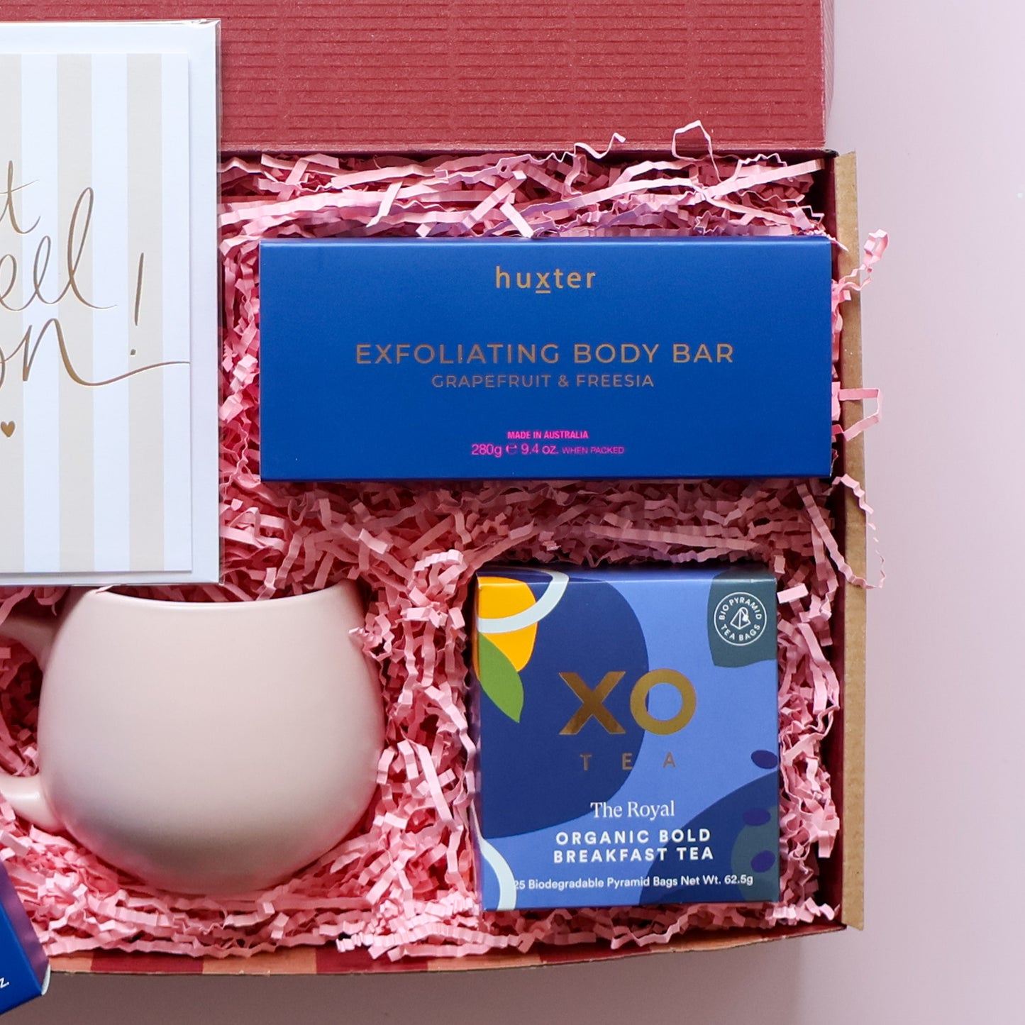 Get well soon gift box detail showing Huxter grapefruit freesia exfoliating body bar XO Tea organic breakfast tea and pink tulip mug Perth