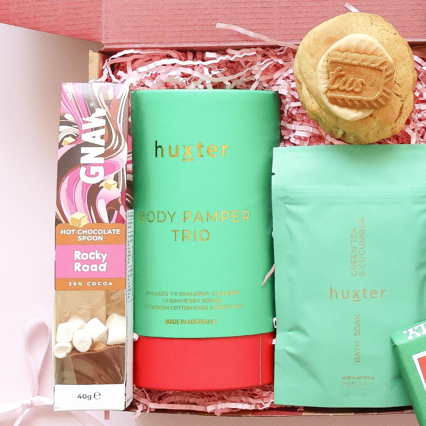 Pamper hamper for her with Huxter body pamper trio, Gnaw rocky road hot chocolate spoon, bath soak and Biscoff cookie