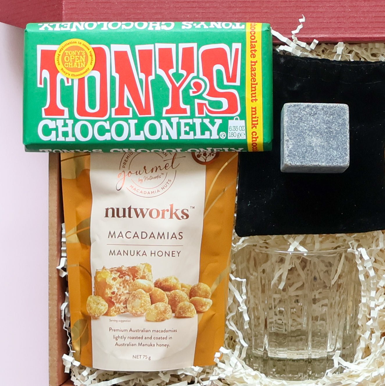 Whisky gift hamper set with whisky glass, stone ice cube, macadamias and chocolate