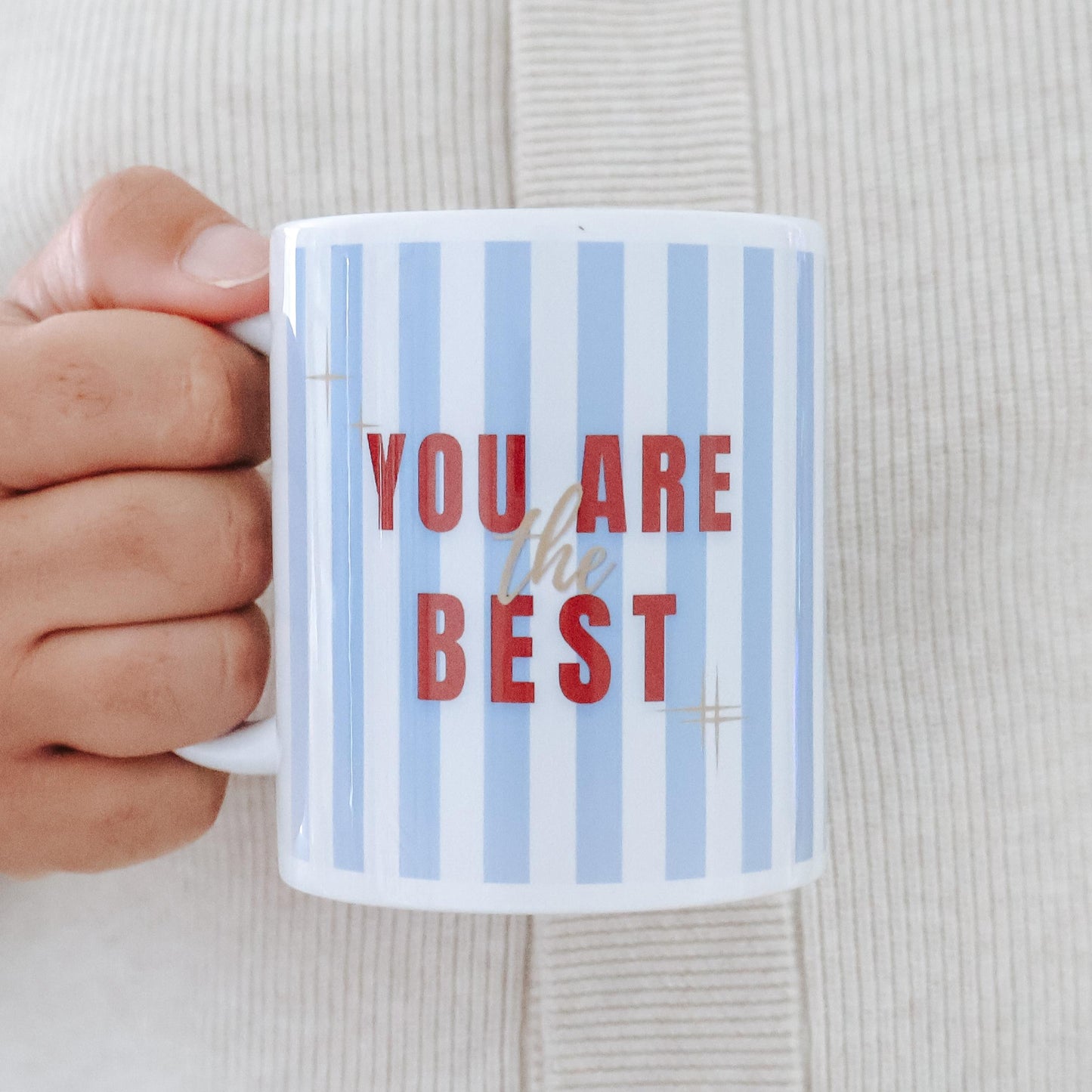 You Are the Best blue and white stripe mug held in hand showing bold red and gold text design – Goodie Box gift box add-on Perth