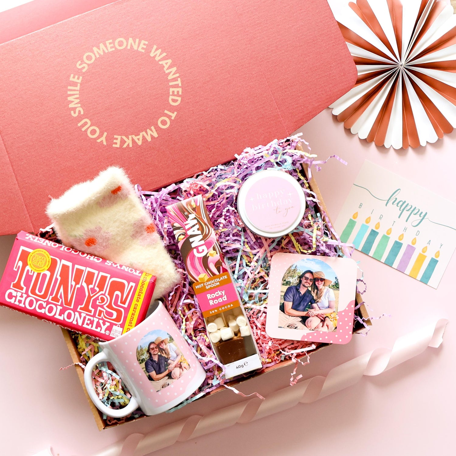 hamper containing body scrub and face masks with a selection of chocolates and lollies. The perfect gift for her.