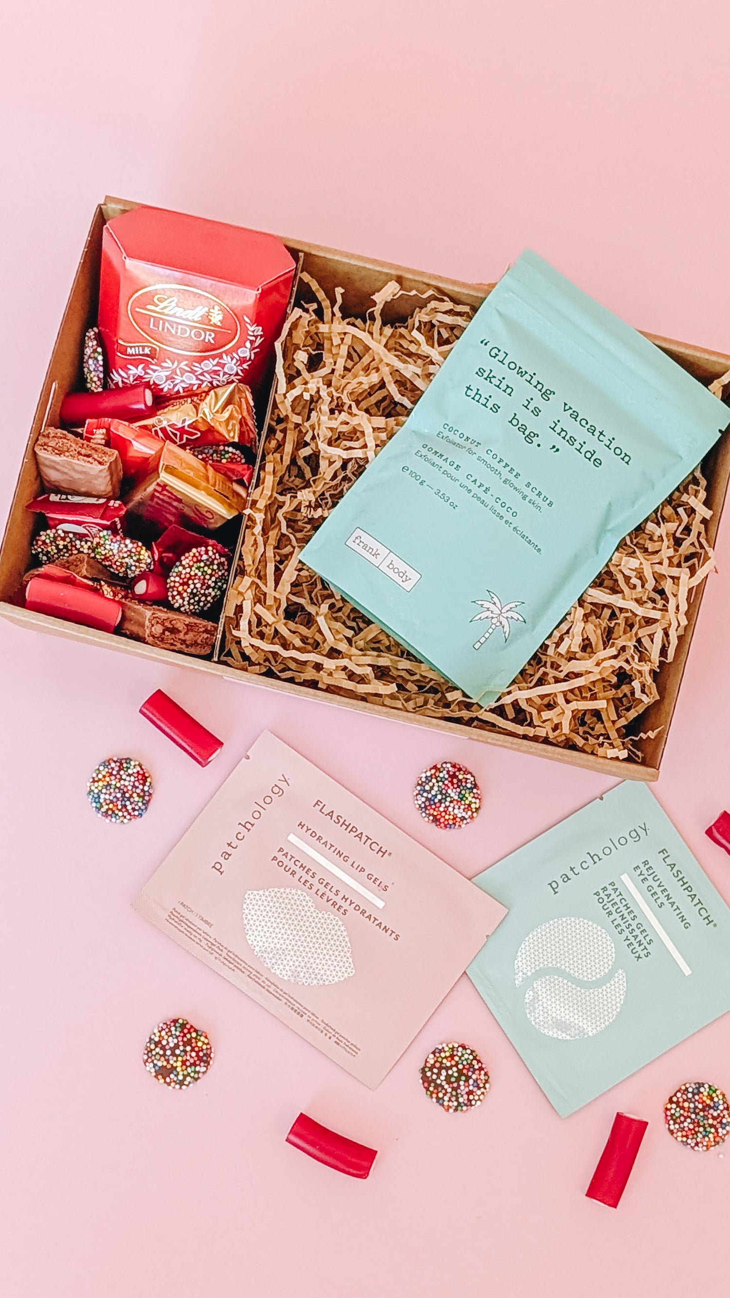 hamper containing body scrub and face masks with a selection of chocolates and lollies. The perfect gift for her.