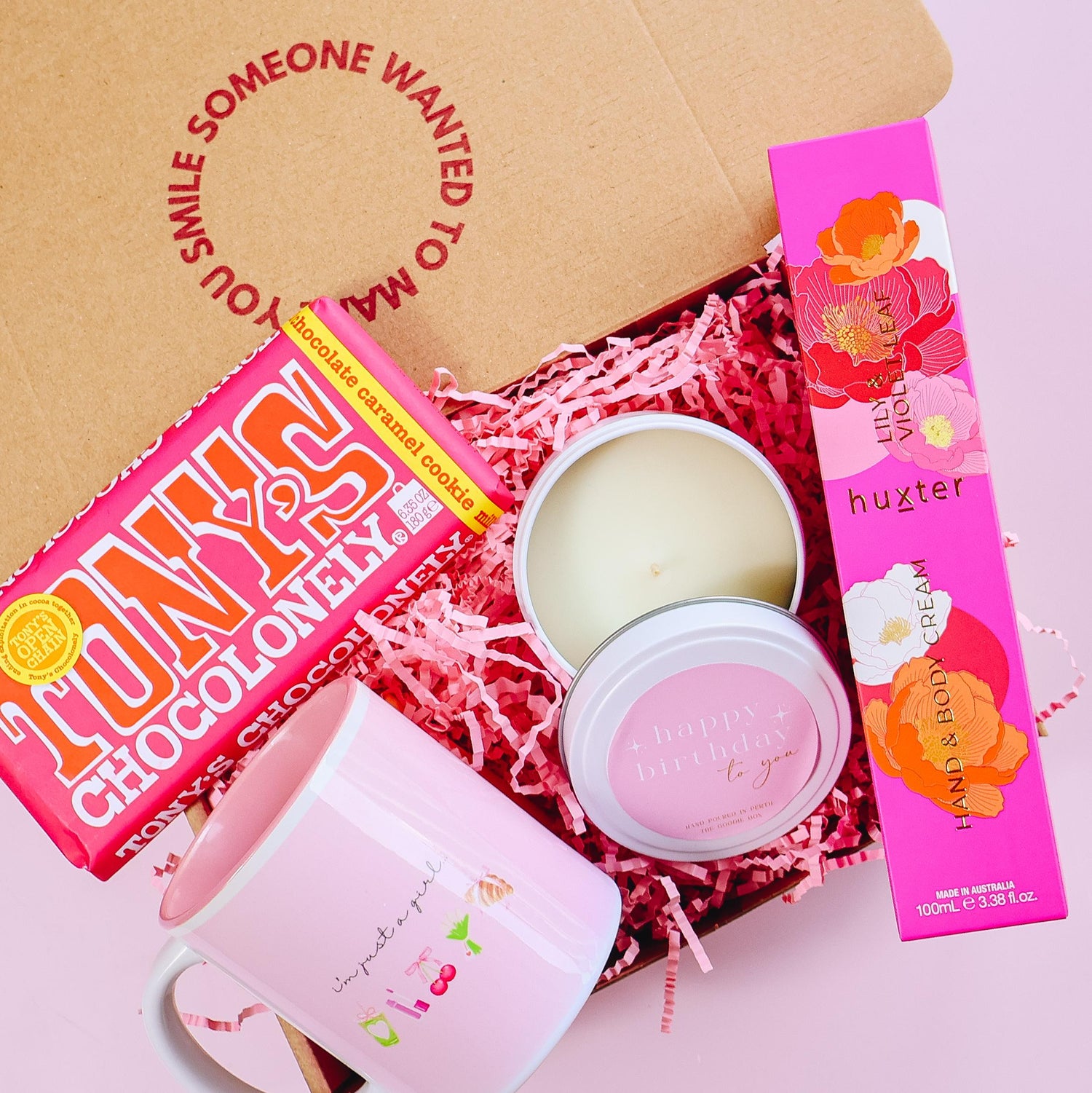 Gift hampers perth showing chocolate, soy candle, hand lotion and mug