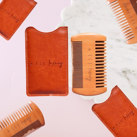 A Lil Luxury engraved wooden beard comb with tan case flatlay on pink background – Goodie Box gift box add-on Perth