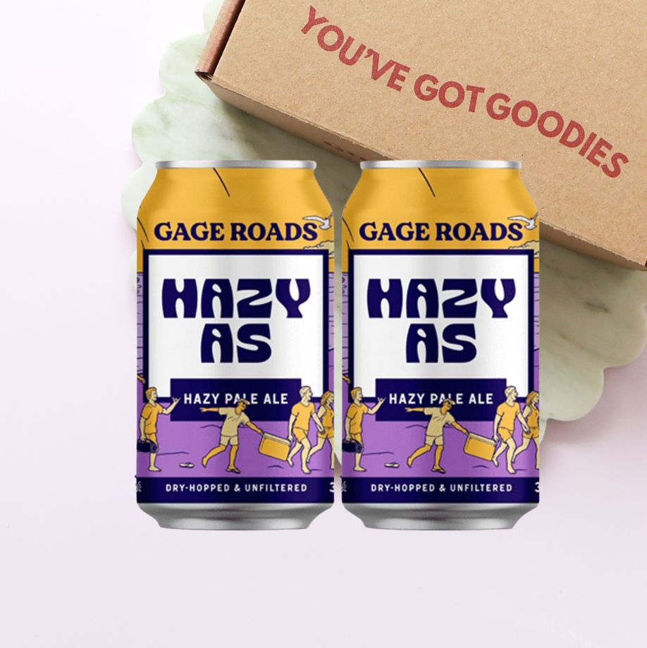 Two cans of Gage Roads Hazy As Hazy Pale Ale with a box labeled 'You've Got Goodies' in the background.