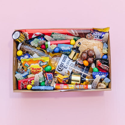Photograph of gift box filled with Corona, Nerds, Cadbury Dairy Milk, Trolli Lollies and an assortment of mini chocolates and loose cookies and sweets.