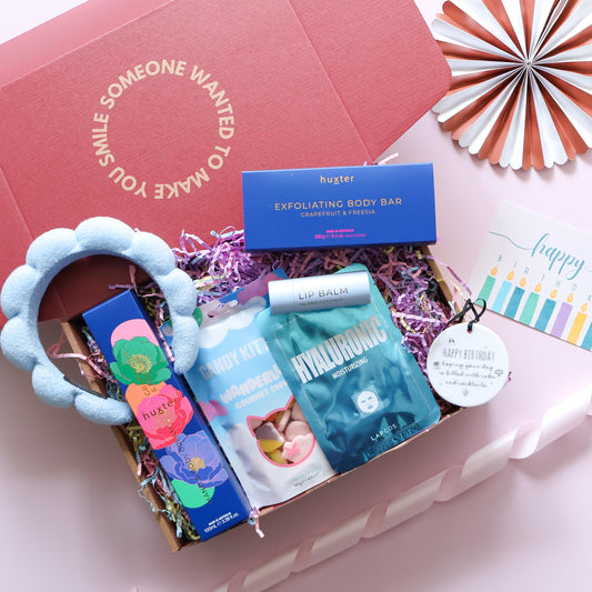 Birthday pamper gift box for her open showing Huxter body bar hand cream Lapcos face mask Candy Kittens lip balm blue spa headband and birthday keepsake disc Perth
