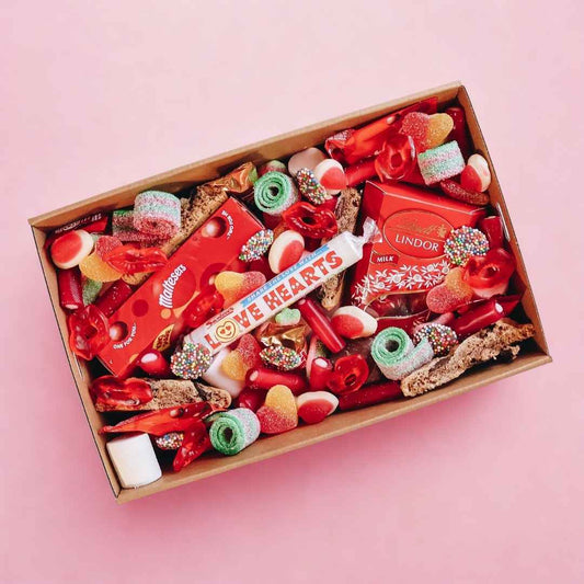 Overhead flatlay of sweet lolly and chocolate gift hamper Perth — same day delivery by The Goodie Box