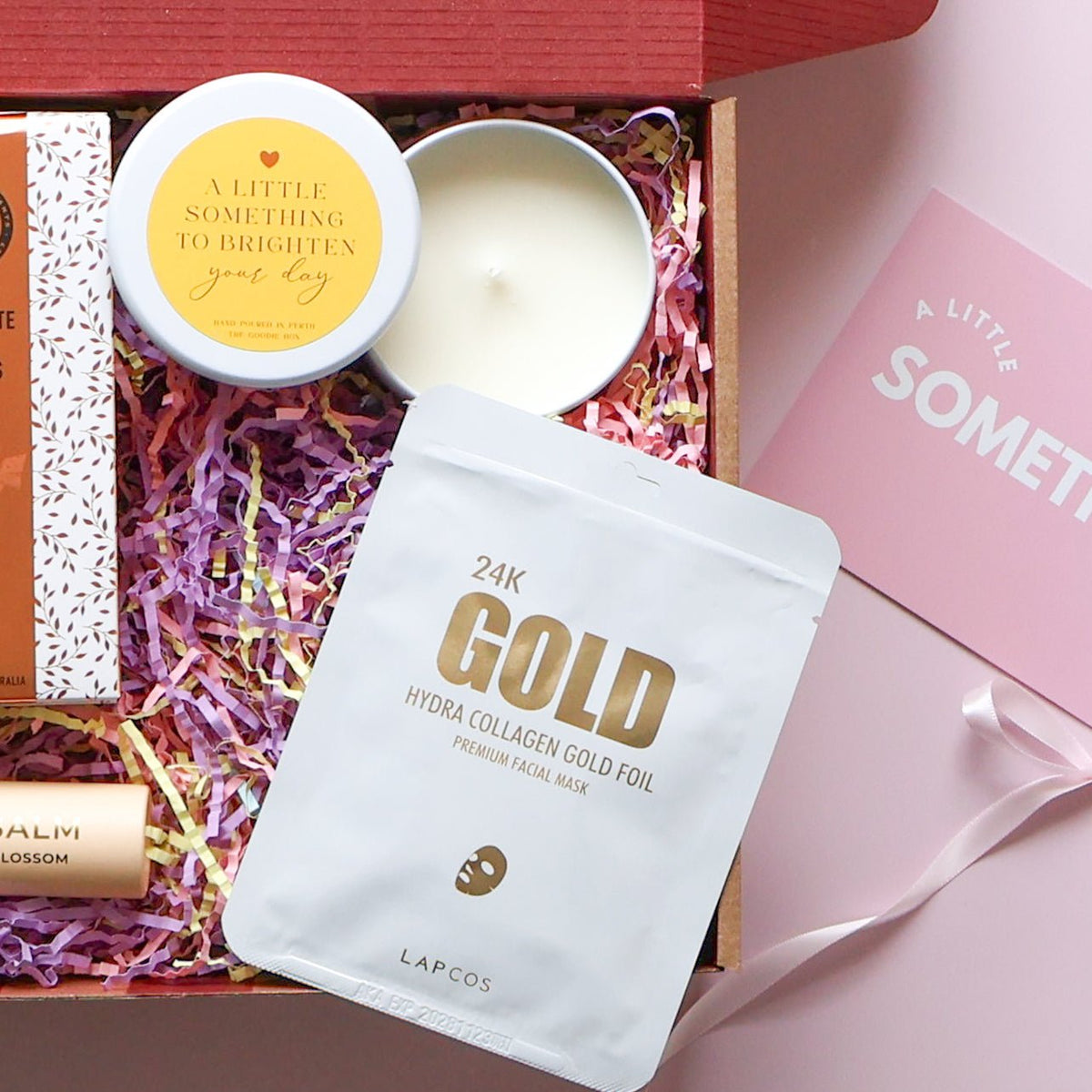 Gold collagen face mask, bow claw clip and Brighten Your Day candle in a brighten your day pamper hamper