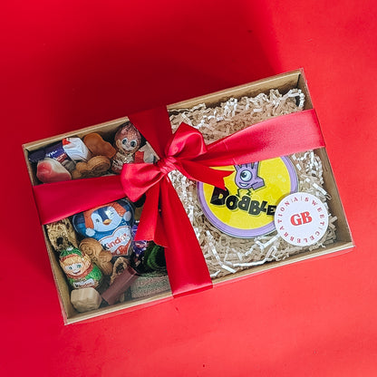 Gift box with toys and a red ribbon on a red background