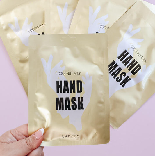 Hand mask packaging with 'Coconut Milk' and 'Lapcos' branding on a pink background