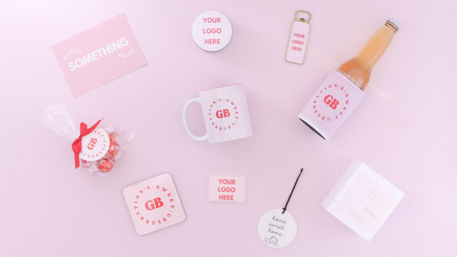 A styled flat-lay of customizable mockup branding items on a light pink background, including a mug, bottle sleeve, coaster, card, sticker, and candle gift with red branding.