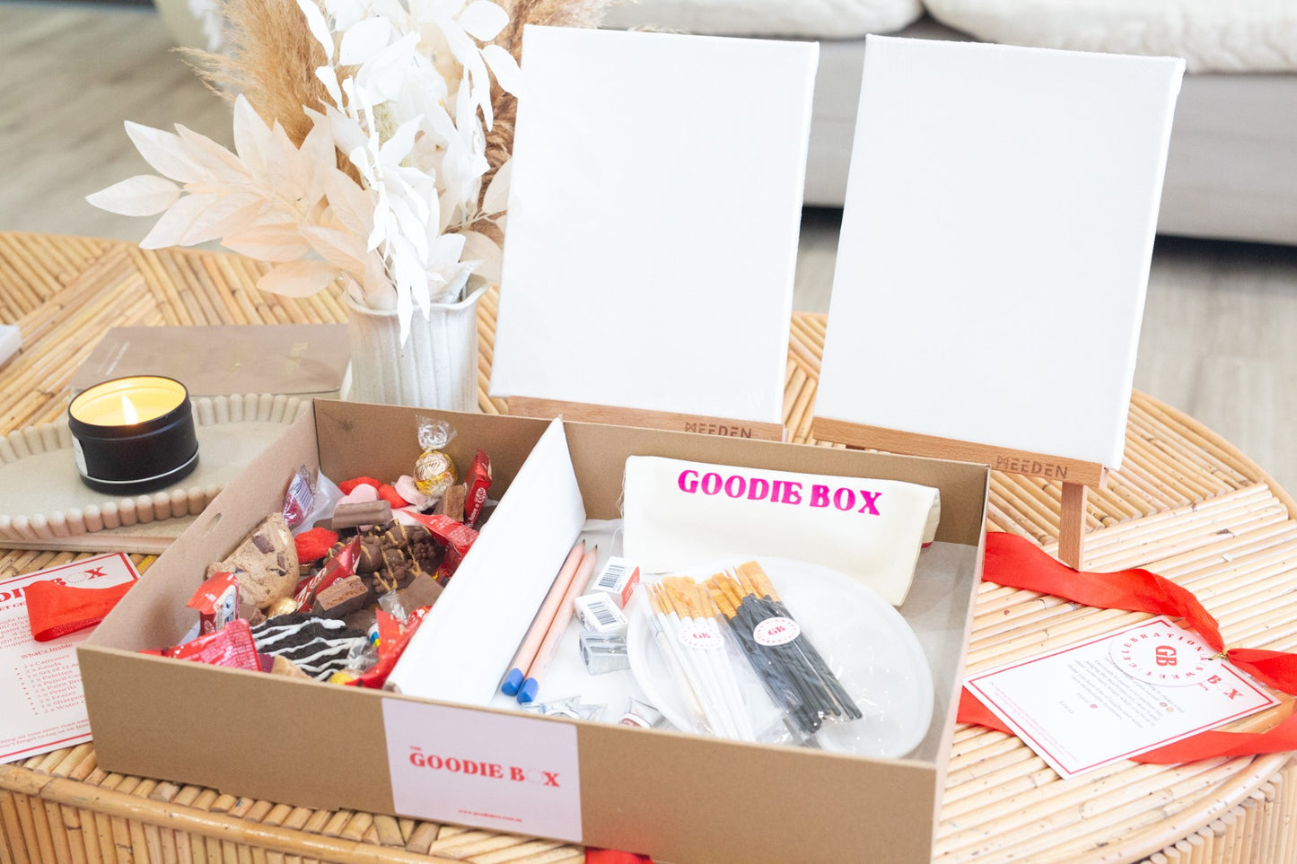 Goodie box with a painting kit and donuts on a table
