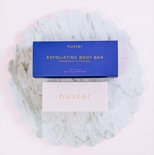 Huxter exfoliating body bar packaging on a marble surface