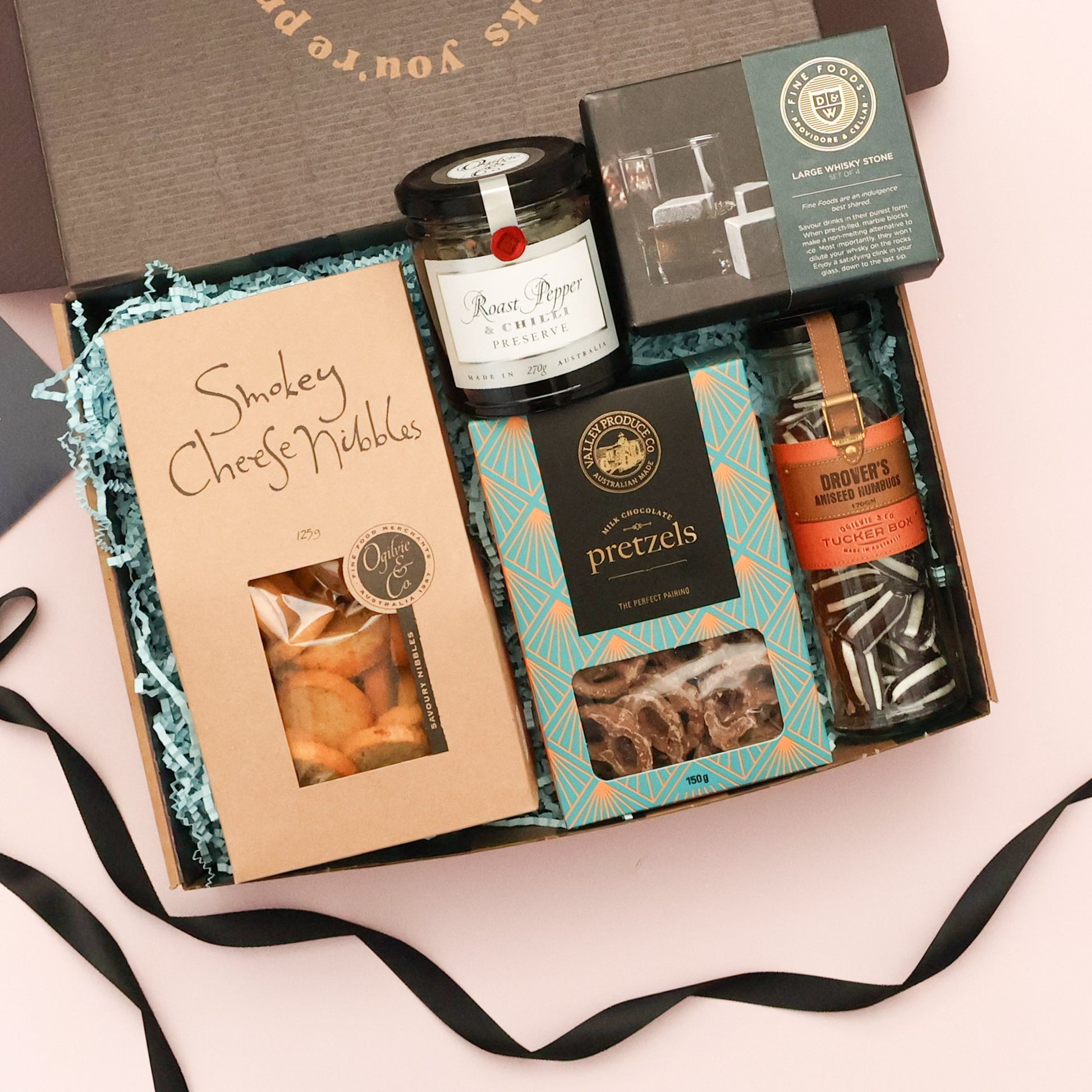 Father's Day gourmet nibbles gift box with smokey cheese bites, chilli preserve, chocolate pretzels and whisky stones