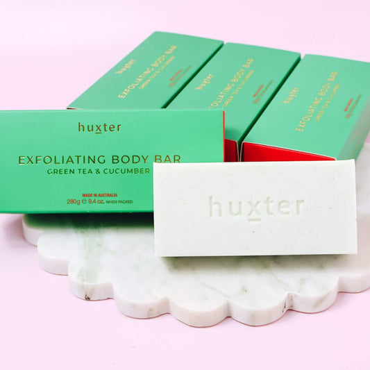 Huxter exfoliating body bars with green tea and cucumber on a pink background