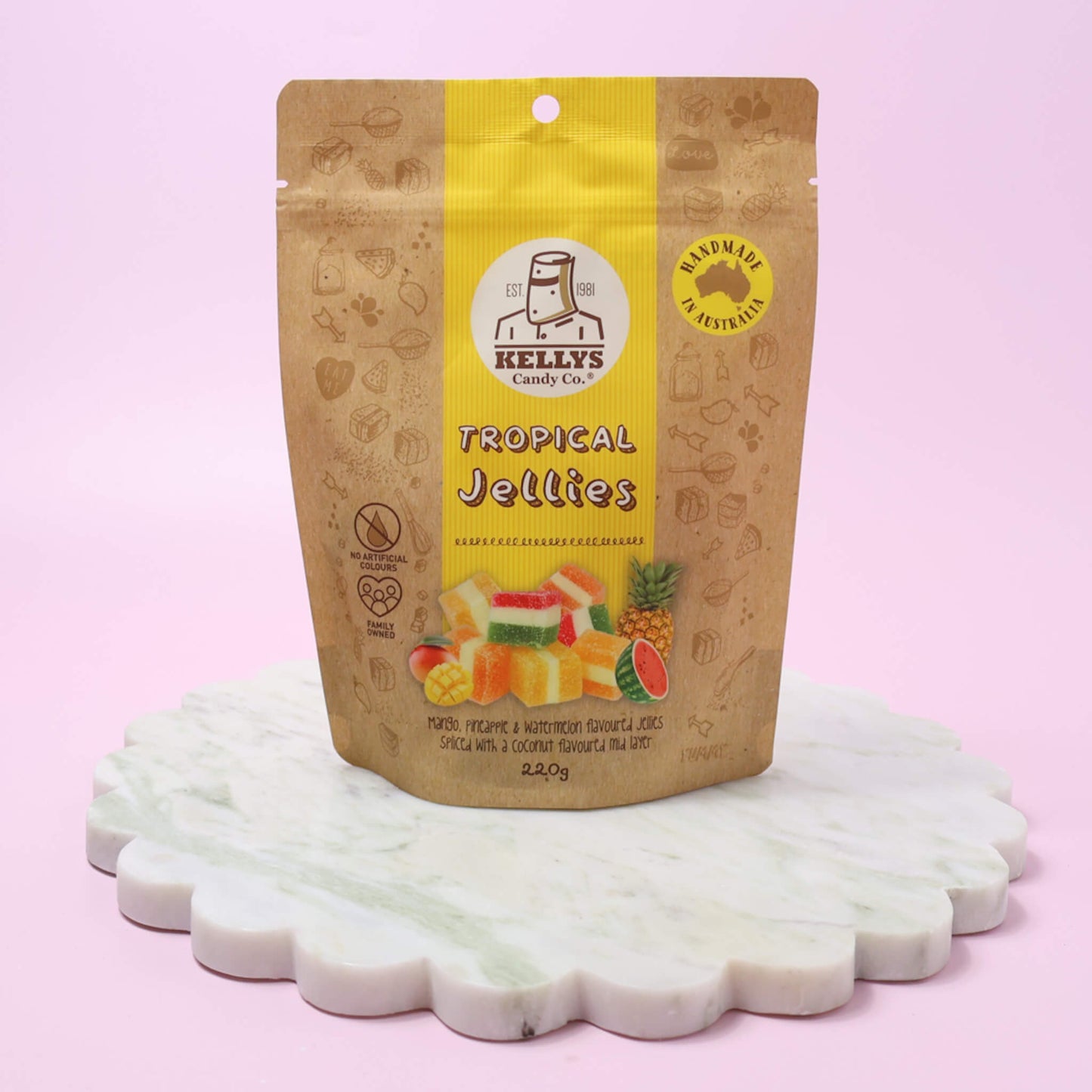 Kellly's Tropical Jellies packaging on a white surface with a pink background