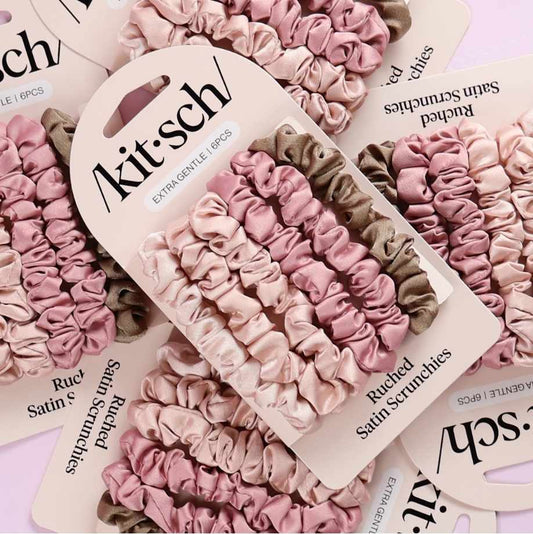Kit-sch scrunchies packaging with pink and brown scrunchies on a pink background