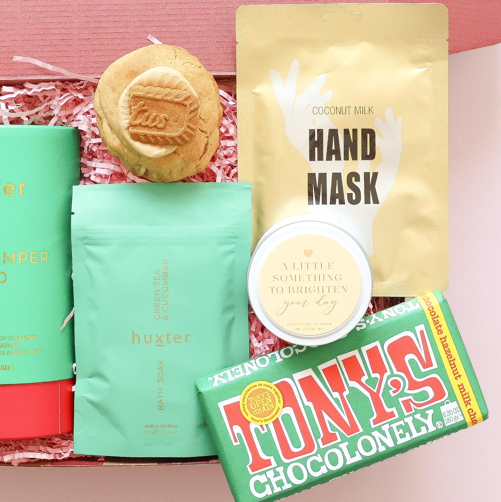 Pamper hamper for her with Huxter bath soak, Biscoff cookie, coconut milk hand mask, candle and Tony's Chocolonely chocolate