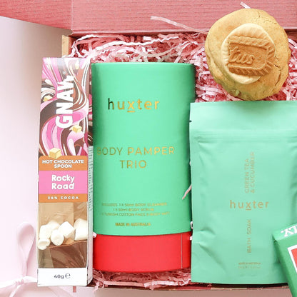 Pamper hamper for her with Huxter body pamper trio, Gnaw rocky road hot chocolate spoon, bath soak and Biscoff cookie

