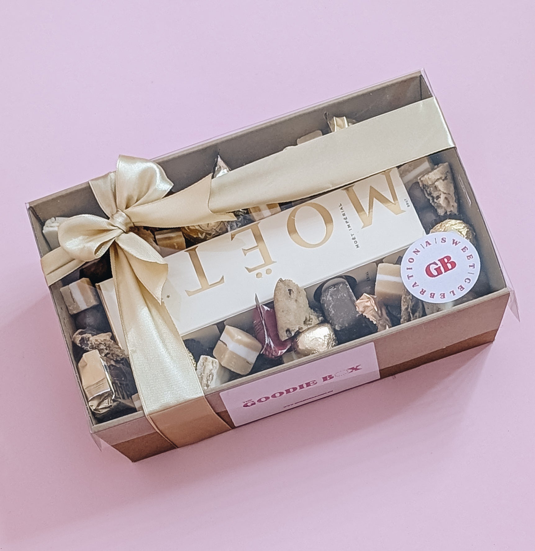 Luxury Moët Champagne and chocolate gift hamper with Bouchee, Ferrero Rocher, Lindt, Whittiker chocolates. Wrapped with a beautiful gold bow ready for gifting. 
