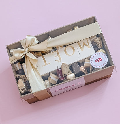 Luxury Moët Champagne and chocolate gift hamper with Bouchee, Ferrero Rocher, Lindt, Whittiker chocolates. Wrapped with a beautiful gold bow ready for gifting. 