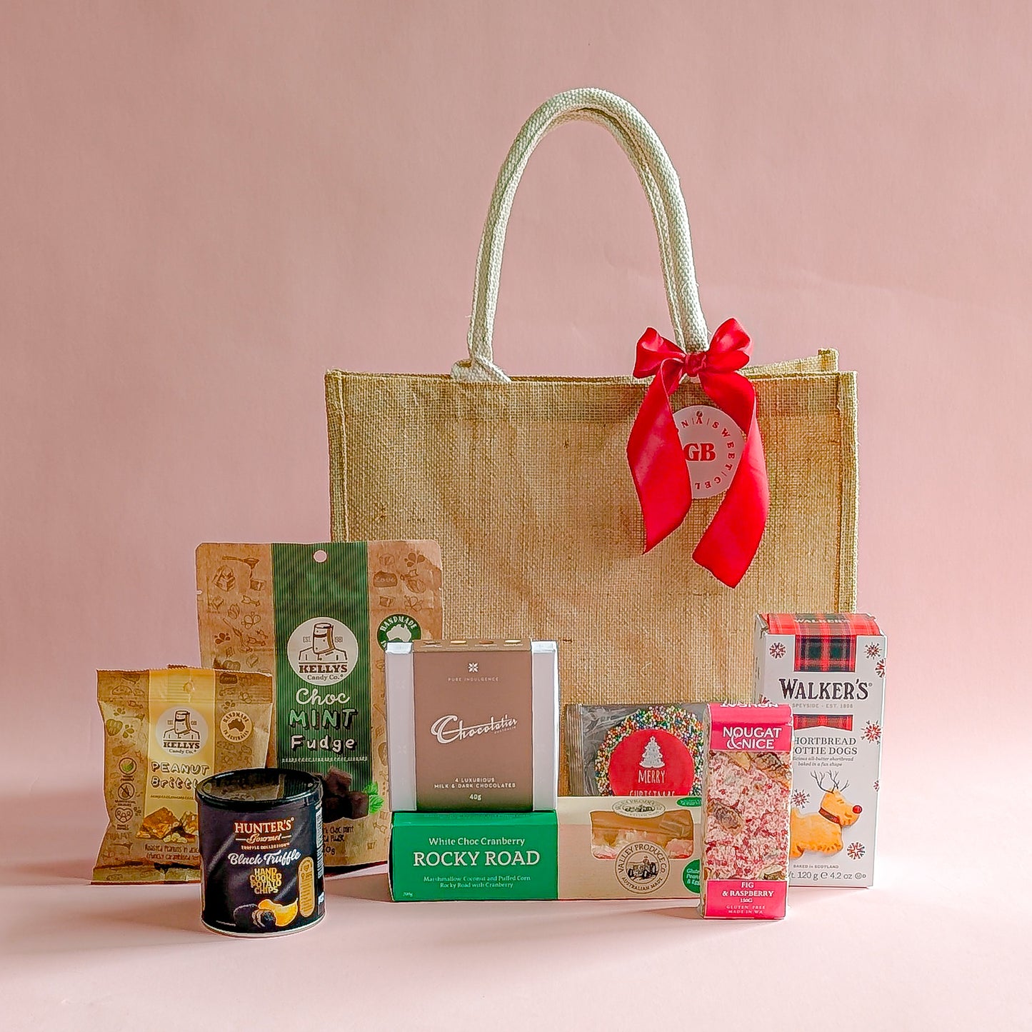 Gift basket with a red ribbon on a pink background