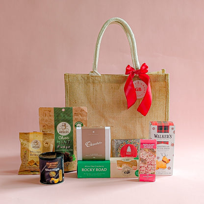 Gift basket with a red ribbon on a pink background