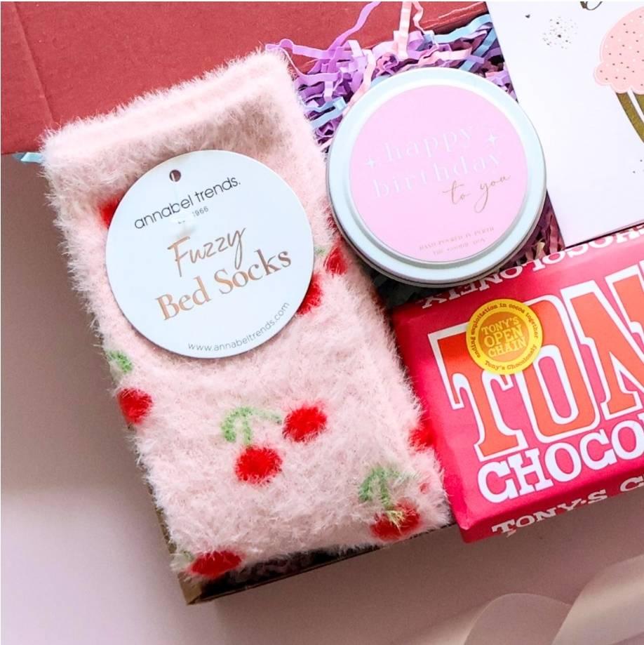 Mini happy birthday gift box for her open showing cherry bed socks Tony's Chocolonely birthday candle and happy birthday card in branded red box Perth