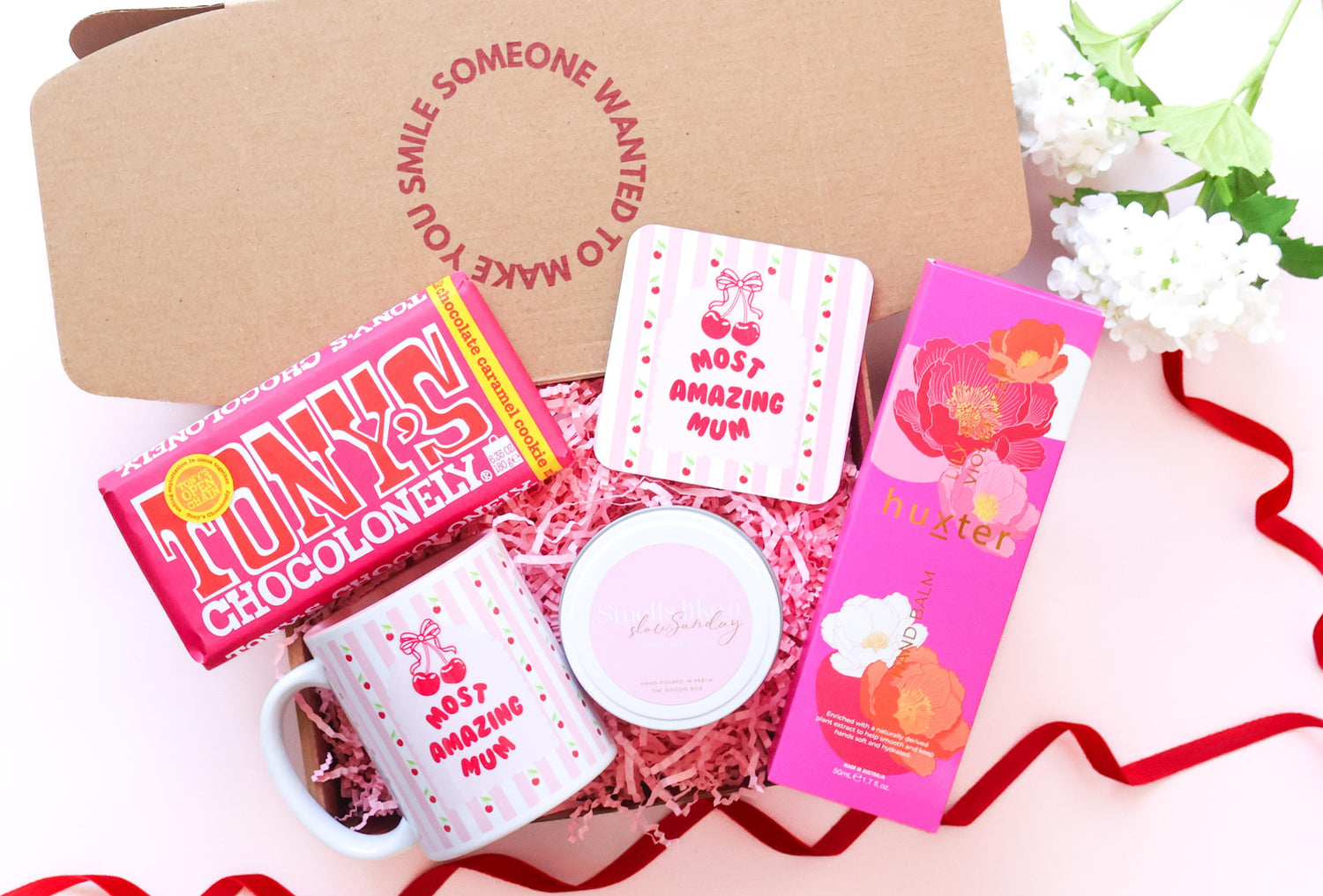 Mothers day Gift set with most amazing mum mug, and matching coaster, lindt lindor chocolate on a pink background