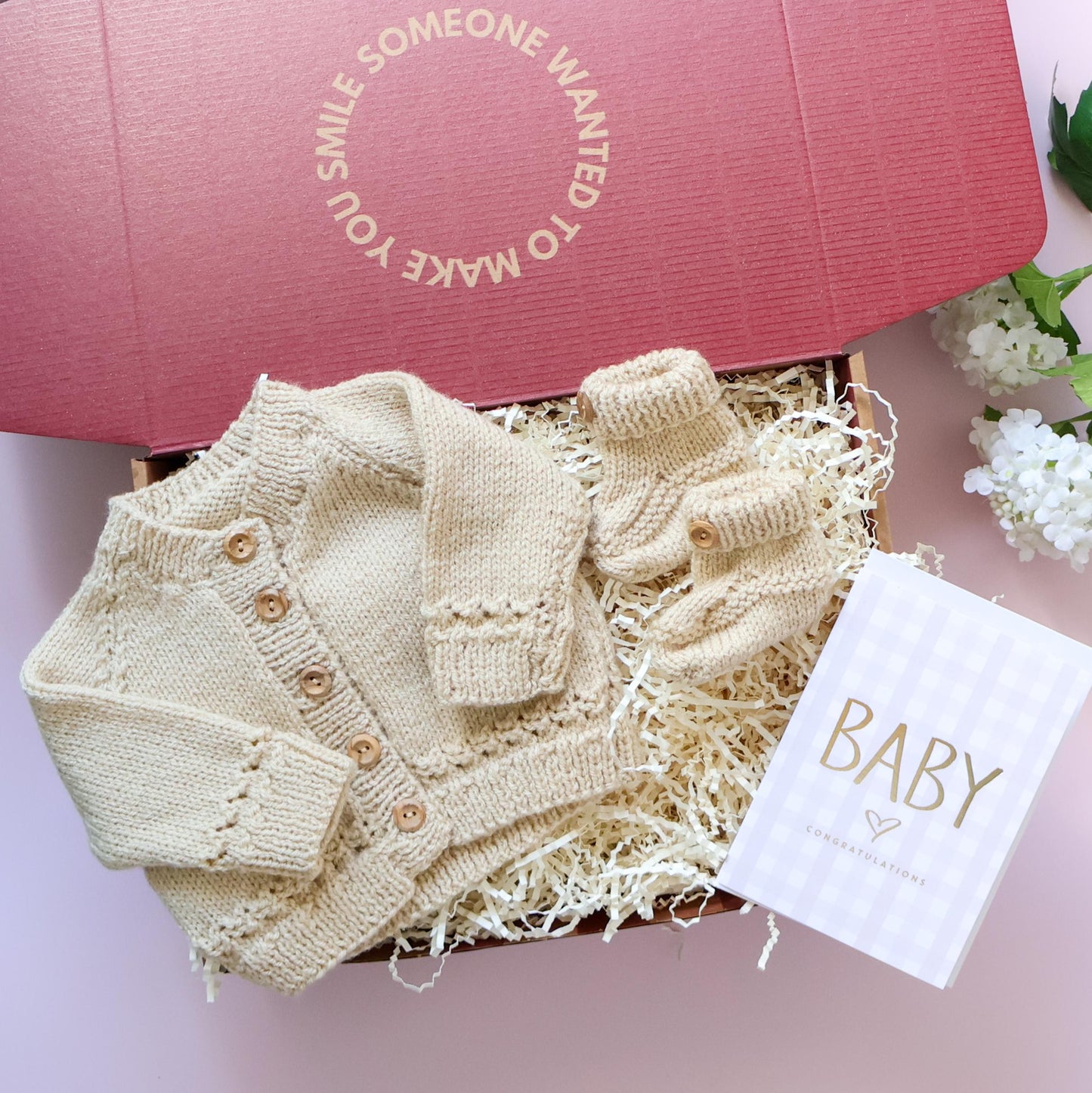 Mini knitted newborn gift box with hand knitted cardigan, booties and Baby Congratulations card