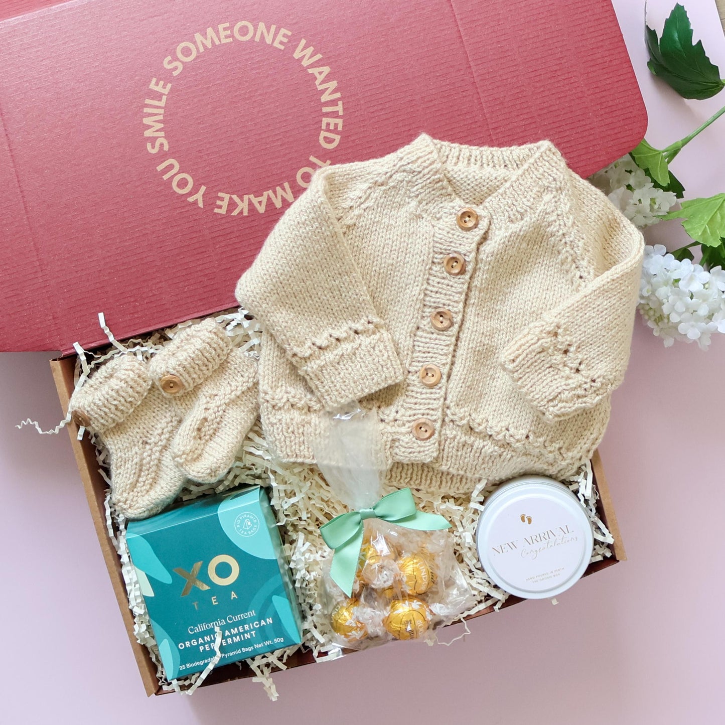 Mum and bub gift box with hand knitted cardigan, booties, XO Tea, Lindt chocolates and New Arrival candle