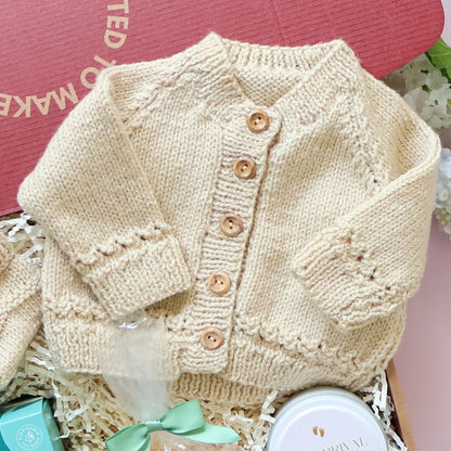 Mum and bub gift box featuring hand knitted Scottish baby cardigan, New Arrival soy candle and Lindt chocolates