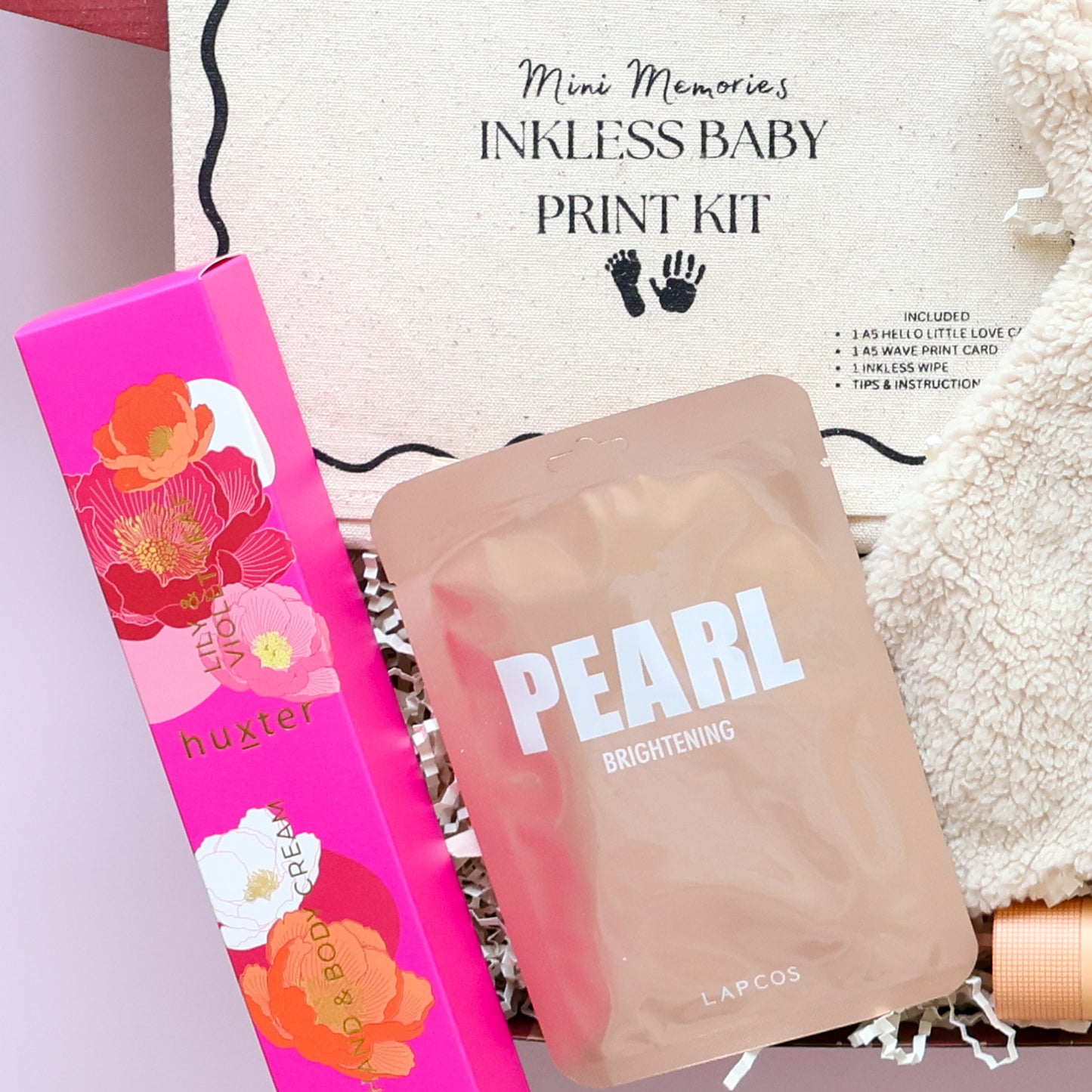 New baby girl gift box featuring Huxter body cream and Lapcos Pearl Brightening K-beauty face mask