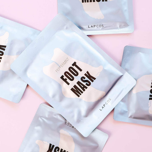 Foot mask packaging with 'LAPCOS' branding on a pink background