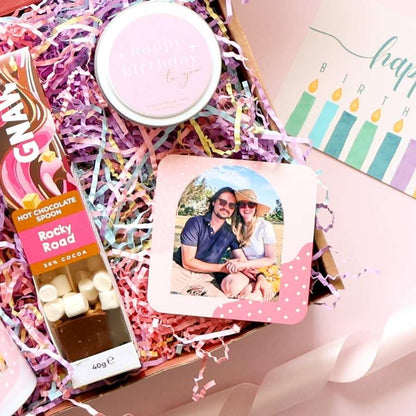 Personalised birthday gift box close up showing custom photo coaster Gnaw Rocky Road hot chocolate spoon birthday candle and gift message postcard Perth