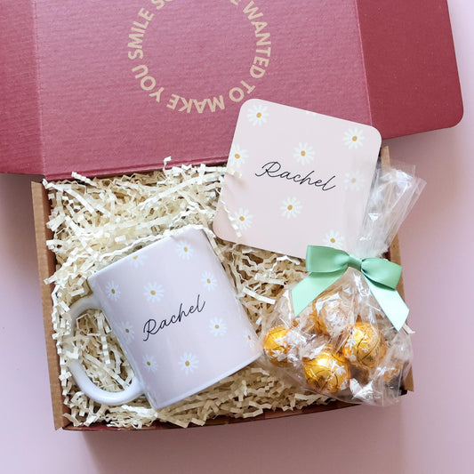 Personalised gift set for her overhead flatlay showing daisy name mug, matching coaster and Lindt Lindor chocolates in open gift box