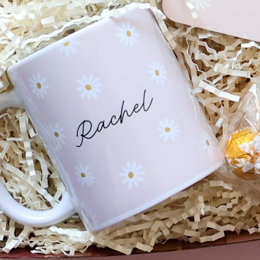  Personalised gift set for her close up of custom daisy name mug with Lindt Lindor chocolate on pink background