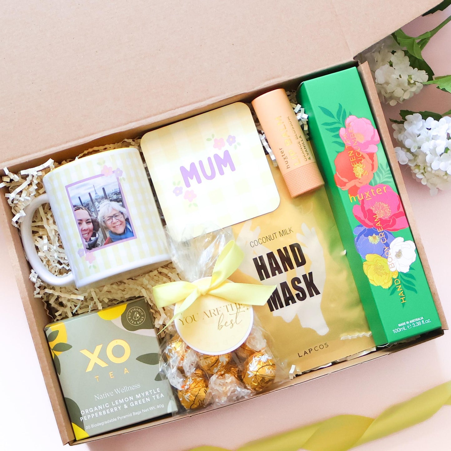 Personalised Mother's Day hamper Perth featuring photo mug, MUM coaster, XO Tea, Lapcos hand mask, Huxter lip balm, hand and body cream and gold Lindt truffles by The Goodie Box