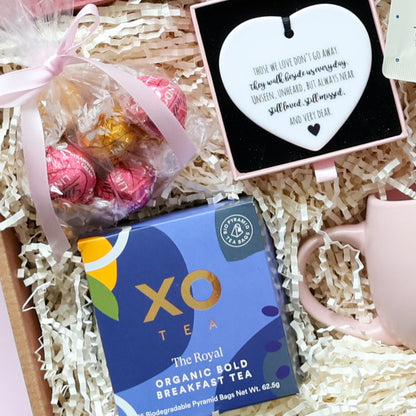 With Sympathy gift box close up showing Lindt Lindor chocolates XO Tea organic breakfast tea ceramic heart keepsake and pink tulip mug Perth