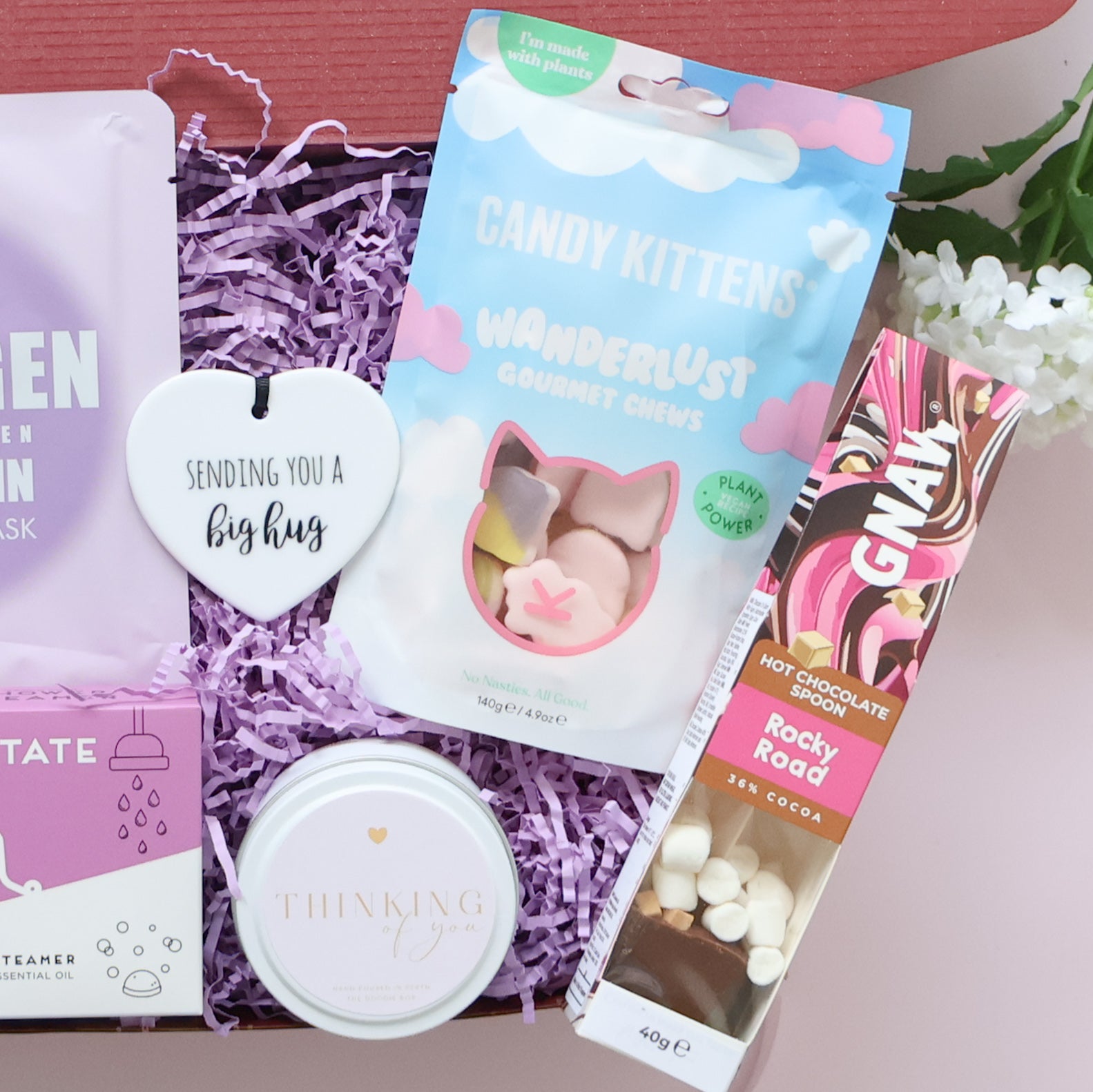 Pamper Gift Box detail showing Sending You a Big Hug ceramic keepsake Candy Kittens Wanderlust chews Thinking of You candle and Gnaw hot chocolate spoon