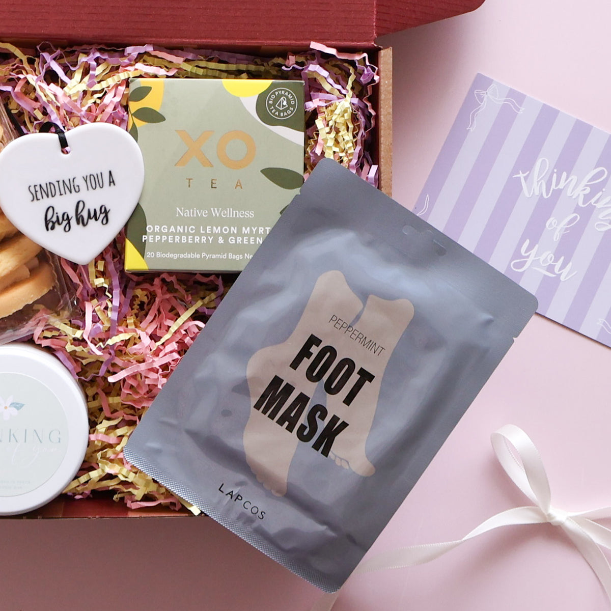 Sending you comfort gift hamper with melting moments, candle, ceramic heart, lemon myrtle tea and foot mask