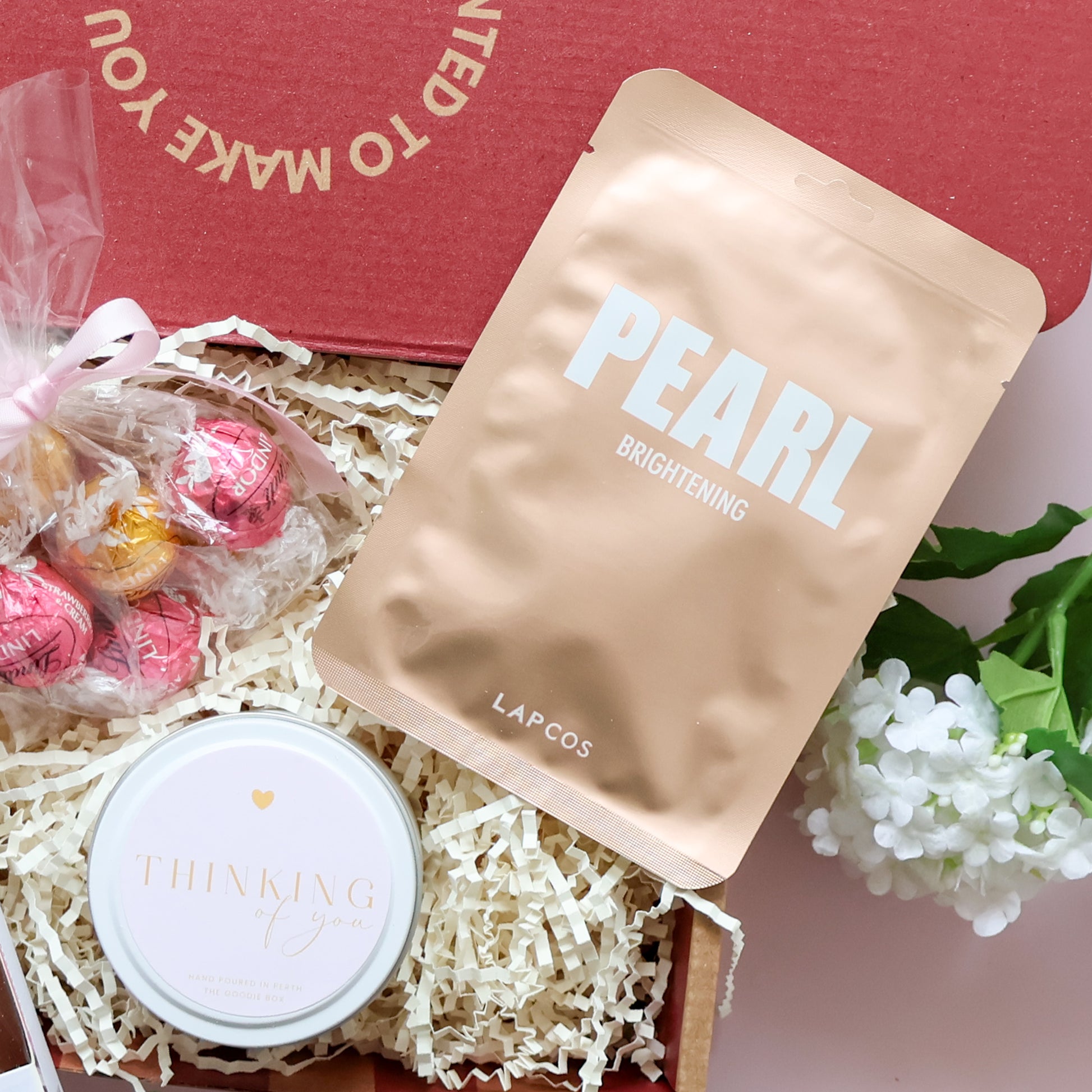 Sending You Comfort gift hamper showing Gnaw rocky road hot chocolate spoon and Lindt Lindor chocolates with pink ribbon
