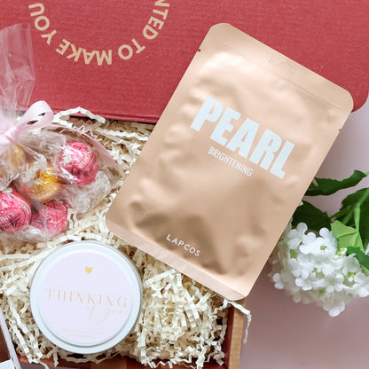 Sending You Comfort gift hamper showing Gnaw rocky road hot chocolate spoon and Lindt Lindor chocolates with pink ribbon