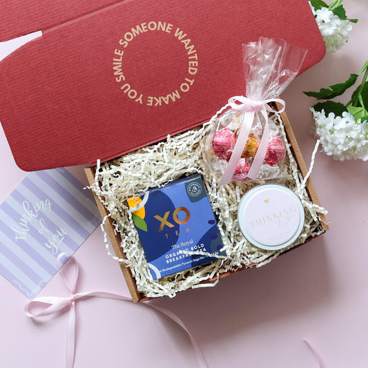 A Little Thinking of You gift box showing XO Tea organic breakfast tea Lindt chocolates and Thinking of You soy candle tin