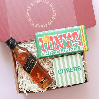 Close up of Tony's Chocolonely chocolate hazelnut and Cheers stripey coaster in thoughtful gift for him 